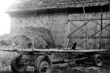 A new wagon next to a barn