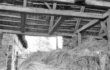 A rafters setting on beams in an old barn