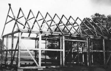 A half-timbered barn under structure