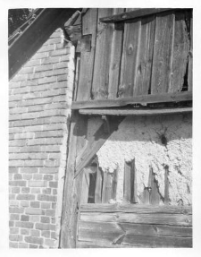 A half-timbered barn, a fragment of a wall