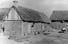 A residential building and a fragment of a barn